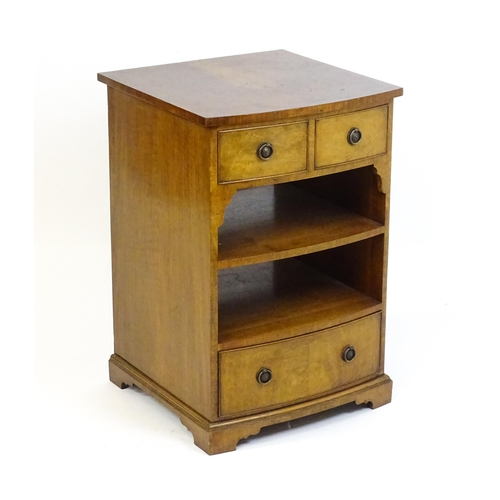 878 - A walnut veneered chest with three small drawers and two shelves raised on short bracket feet. 20