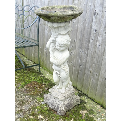 900 - Garden & Architectural : a large reconstituted stone bird bath modelled as a cherub, standing approx... 