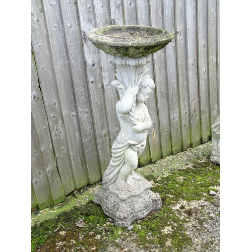 900 - Garden & Architectural : a large reconstituted stone bird bath modelled as a cherub, standing approx... 