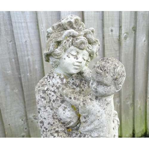 901 - Garden & Architectural : a reconstituted stone statue formed as a mother and child, standing approx ... 