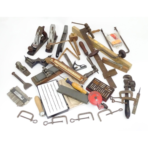 302 - A quantity of mid to late 20thC hand tools , to include saws, drills, planes, vice, socket set, rule... 