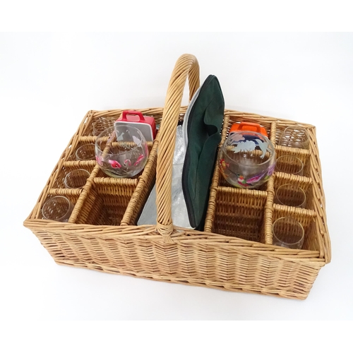 309 - A wicker picnic basket with divisions for bottles, glasses, etc. Together with assorted glasses and ... 