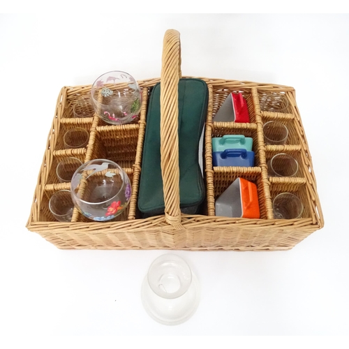 309 - A wicker picnic basket with divisions for bottles, glasses, etc. Together with assorted glasses and ... 