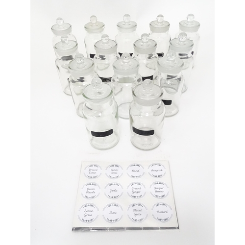310 - A quantity of glass spice jars together with various spice labels, each jar approx 6
