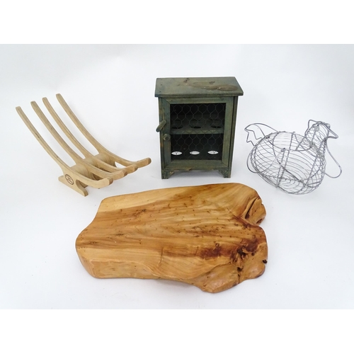 312 - A quantity of assorted kitchenalia to include a wooden chopping board, egg basket / holder, etc.