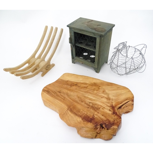 312 - A quantity of assorted kitchenalia to include a wooden chopping board, egg basket / holder, etc.