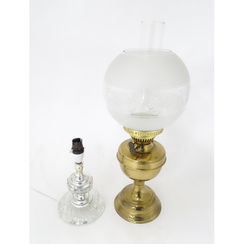 400 - A 20thC brass oil lamp. Together with a table lamp. Oil lamp approx. 20 1/2