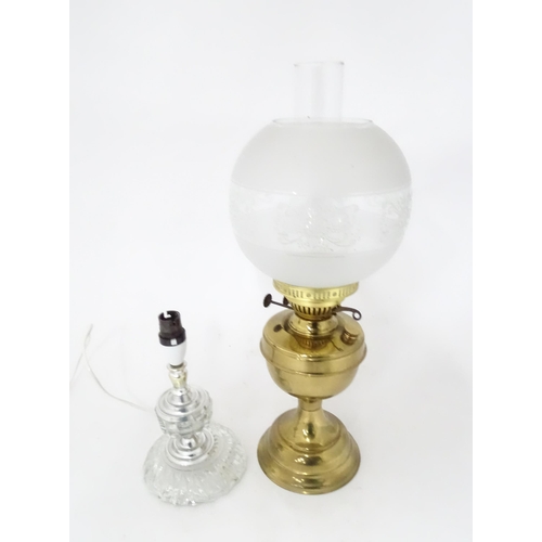 400 - A 20thC brass oil lamp. Together with a table lamp. Oil lamp approx. 20 1/2