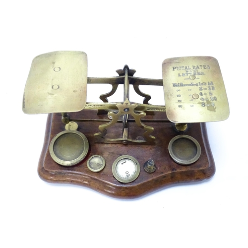 708 - Postal scales by T. J. Smith, Son & Co. of London. Together with associated weights, a stamp box, an... 
