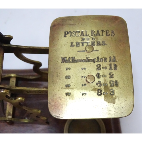 708 - Postal scales by T. J. Smith, Son & Co. of London. Together with associated weights, a stamp box, an... 