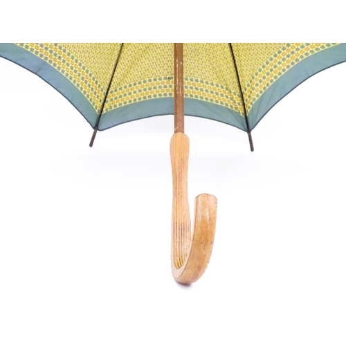 719 - An 'Eldonian' shooting stick, together with a mid 20thC umbrella with a carved wooden handle, and a ... 