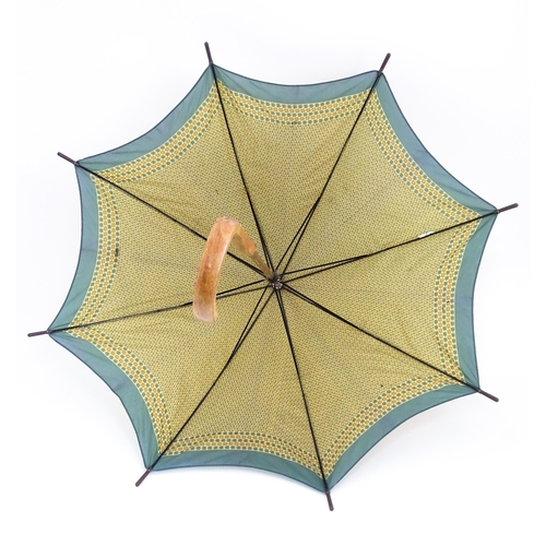 719 - An 'Eldonian' shooting stick, together with a mid 20thC umbrella with a carved wooden handle, and a ... 