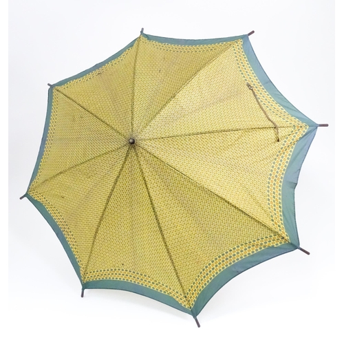 719 - An 'Eldonian' shooting stick, together with a mid 20thC umbrella with a carved wooden handle, and a ... 