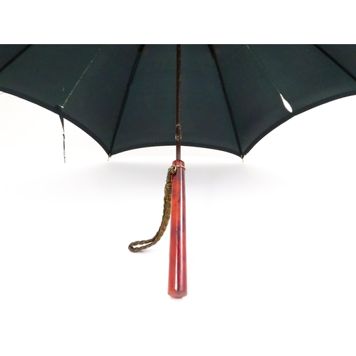 719 - An 'Eldonian' shooting stick, together with a mid 20thC umbrella with a carved wooden handle, and a ... 