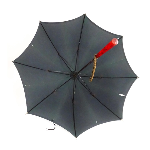 719 - An 'Eldonian' shooting stick, together with a mid 20thC umbrella with a carved wooden handle, and a ... 