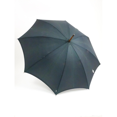 719 - An 'Eldonian' shooting stick, together with a mid 20thC umbrella with a carved wooden handle, and a ... 