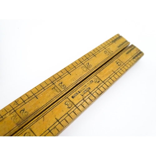 727 - A quantity of rules and rulers to include folding boxwood examples. Together with various magnifying... 