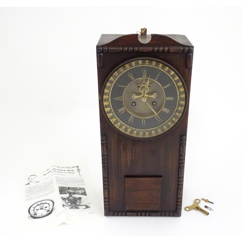 729 - An Edwardian wall clock, the stained oak case housing a black and gilt numeral dial with Brocot visi... 