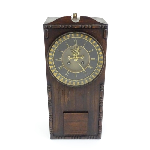 729 - An Edwardian wall clock, the stained oak case housing a black and gilt numeral dial with Brocot visi... 