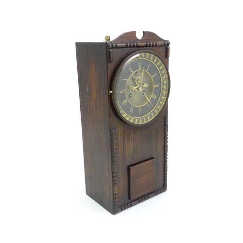 729 - An Edwardian wall clock, the stained oak case housing a black and gilt numeral dial with Brocot visi... 