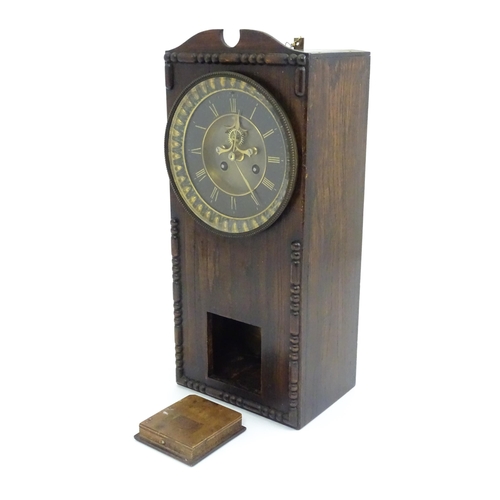 729 - An Edwardian wall clock, the stained oak case housing a black and gilt numeral dial with Brocot visi... 