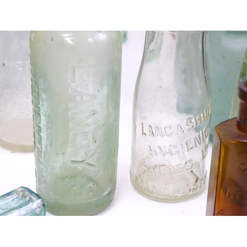 76 - A quantity of early to mid 20thC glass bottles, to include codd lemonade / soda bottles, brown glass... 