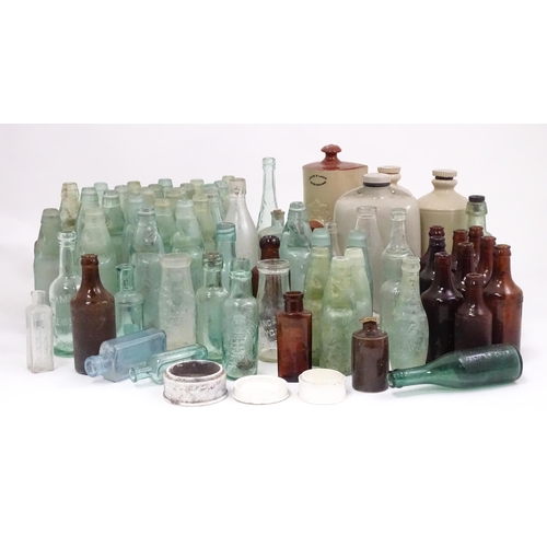 76 - A quantity of early to mid 20thC glass bottles, to include codd lemonade / soda bottles, brown glass... 