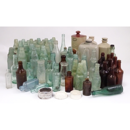 76 - A quantity of early to mid 20thC glass bottles, to include codd lemonade / soda bottles, brown glass... 