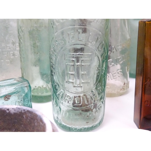 76 - A quantity of early to mid 20thC glass bottles, to include codd lemonade / soda bottles, brown glass... 