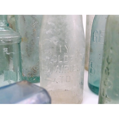 76 - A quantity of early to mid 20thC glass bottles, to include codd lemonade / soda bottles, brown glass... 