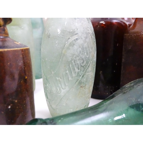 76 - A quantity of early to mid 20thC glass bottles, to include codd lemonade / soda bottles, brown glass... 