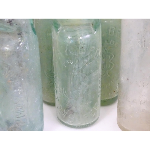 76 - A quantity of early to mid 20thC glass bottles, to include codd lemonade / soda bottles, brown glass... 