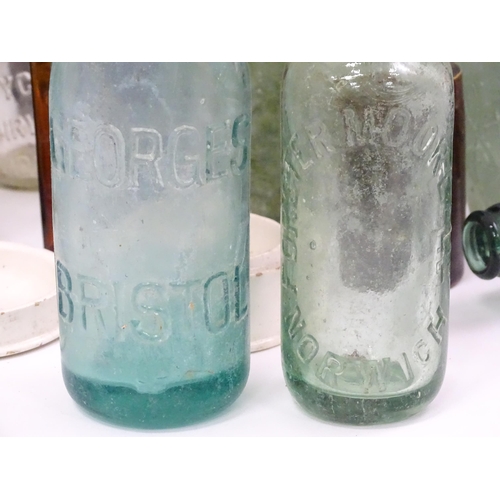 76 - A quantity of early to mid 20thC glass bottles, to include codd lemonade / soda bottles, brown glass... 