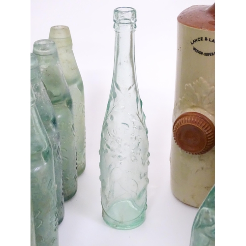 76 - A quantity of early to mid 20thC glass bottles, to include codd lemonade / soda bottles, brown glass... 