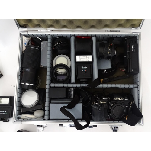 806 - A Minolta X-700 35mm SLR Film Camera together with a quantity of lenses and equipment to include a M... 