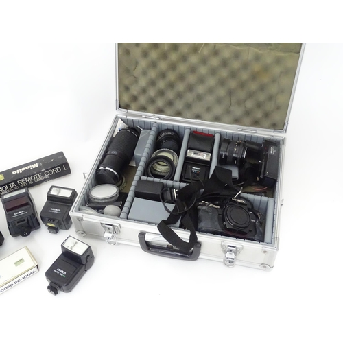 806 - A Minolta X-700 35mm SLR Film Camera together with a quantity of lenses and equipment to include a M... 