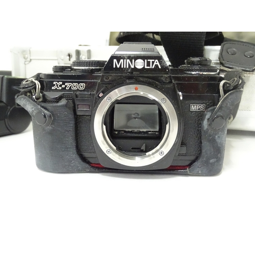 806 - A Minolta X-700 35mm SLR Film Camera together with a quantity of lenses and equipment to include a M... 