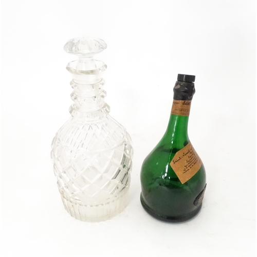 808 - A 20thC cut glass decanter and stopper. Together with a shaped green bottle labelled Saint Vivant Ar... 