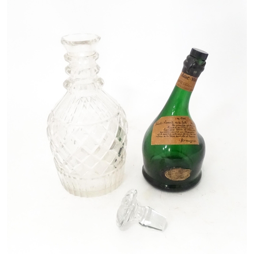 808 - A 20thC cut glass decanter and stopper. Together with a shaped green bottle labelled Saint Vivant Ar... 