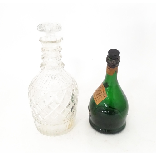 808 - A 20thC cut glass decanter and stopper. Together with a shaped green bottle labelled Saint Vivant Ar... 
