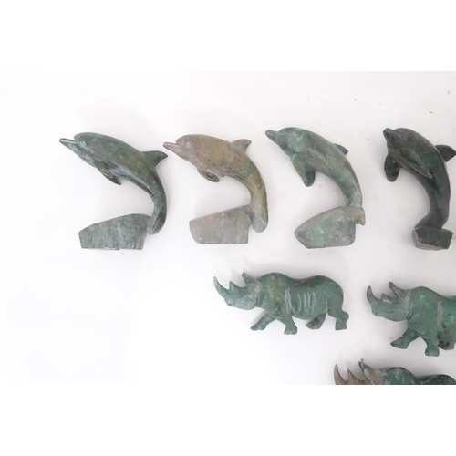 812 - A quantity of carved soapstone animals to include dolphins and rhinos. Largest approx. 4 1/4