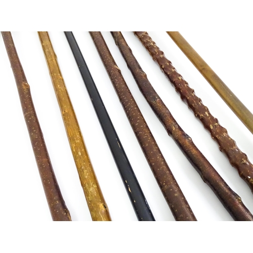 829 - A quantity of walking sticks / canes, comprising a hazel stick with antler handle and whistle tip, a... 