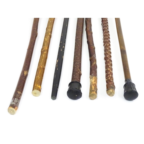 829 - A quantity of walking sticks / canes, comprising a hazel stick with antler handle and whistle tip, a... 