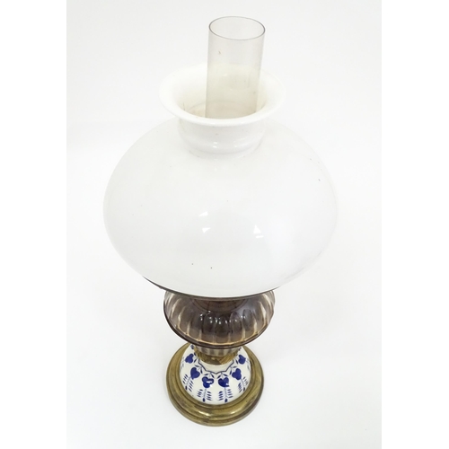 851 - Two late 19thC / early 20thC oil lamps, one with glass reservoir. Tallest approx. 23