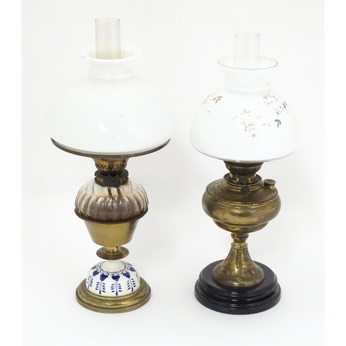 851 - Two late 19thC / early 20thC oil lamps, one with glass reservoir. Tallest approx. 23