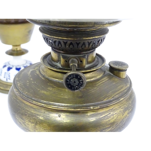 851 - Two late 19thC / early 20thC oil lamps, one with glass reservoir. Tallest approx. 23