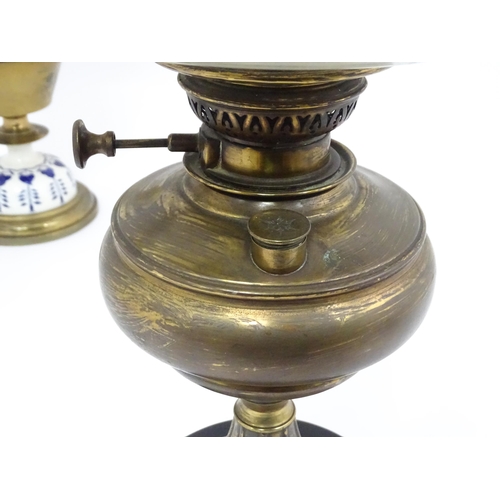 851 - Two late 19thC / early 20thC oil lamps, one with glass reservoir. Tallest approx. 23