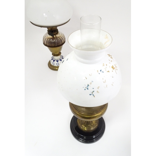 851 - Two late 19thC / early 20thC oil lamps, one with glass reservoir. Tallest approx. 23