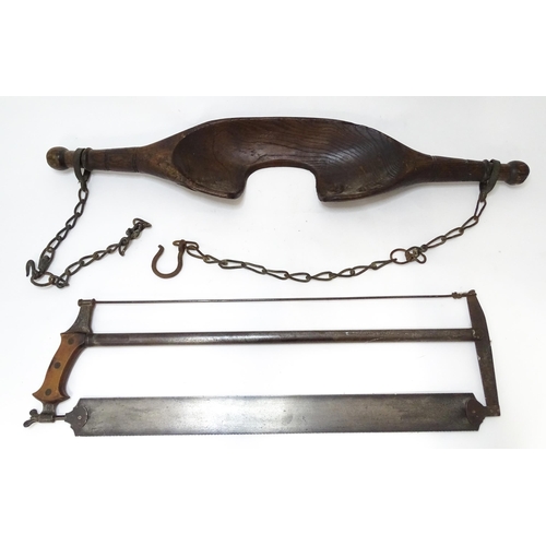 872 - A 19thC carved shoulder yoke, together with a late 19thC bow saw with a mahogany handle stamped '712... 