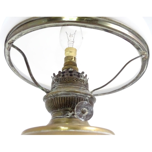391 - A quantity of assorted table lamps, to include examples of oil lamp form, one formed as a Corinthian... 